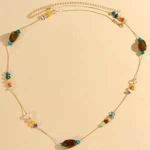 Macro view of ethnic style waist chain with irregular colored stones and gold chain