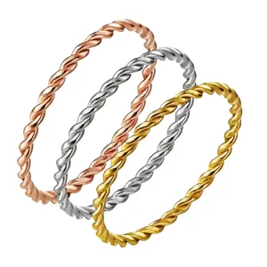 Three-piece set of twisted rope stackable rings in gold, silver, and rose gold finish