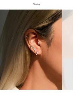Detailed view of S925 sterling silver moissanite stud earrings worn on a human ear.