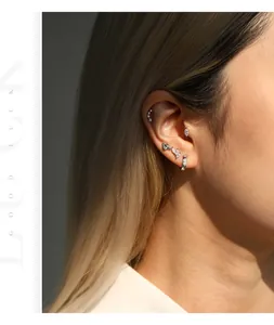 Close-up of S925 sterling silver moissanite earrings worn on ear