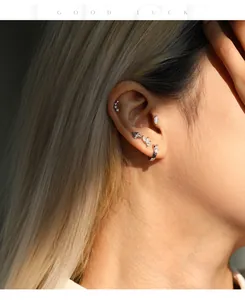 Detail view of S925 sterling silver moissanite stud earrings worn on a female model's ear