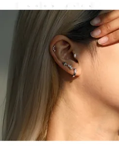 Detailed view of multiple S925 sterling silver stud earrings with moissanite stones