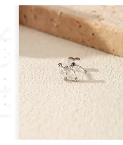 Detailed macro view showing a leaf-shaped S925 silver stud earring with moissanite stones