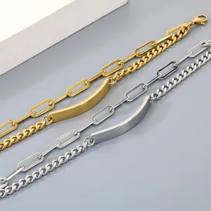 Detail showing minimalist gold and silver double-layer curb and paperclip chain bracelets
