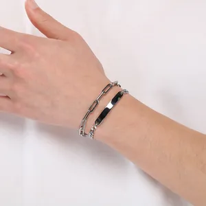 Close-up view of a silver titanium steel double-layer chain bracelet with engravable curved plate