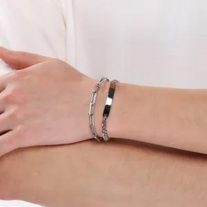 Detail view of silver titanium steel double layer bracelet with engravable curved plate.