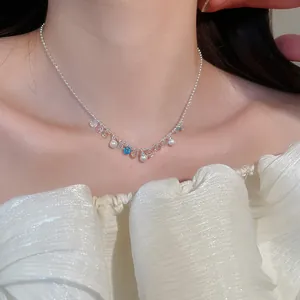 Detail view of colorful zircon and pearl necklace on model's neck - Elegant jewelry