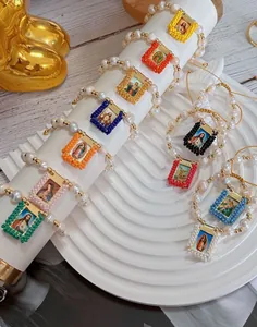 Multi-color religious beaded bracelets with pearls and handmade icons shown in detail