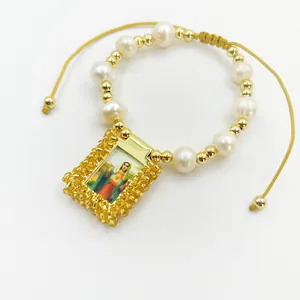 Close-up of retro religious bracelet with natural pearls and Virgin Mary pendant