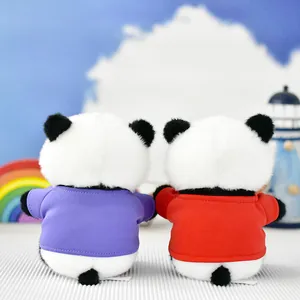 Rear view of two cute panda plush toys wearing purple and red shirts on bright background