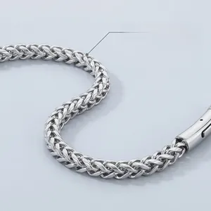 Close-up of tightly woven titanium steel chain with high-gloss metallic texture