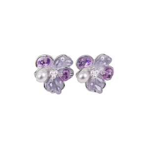 Elegant flower-shaped silver stud earrings with purple crystals and pearls for women