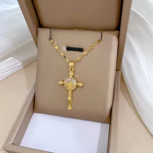 Elegant gold cross pendant necklace with portrait relief and crystals in a luxury gift box