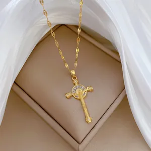Macro shot of gold-plated cross pendant with brilliant zircon and flat ring chain