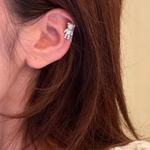 Close-up of a sparkling silver bear ear cuff worn on the cartilage for a stylish look