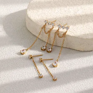 Close-up of 18K gold-plated earrings with sparkling cubic zirconia and long chain tassels.