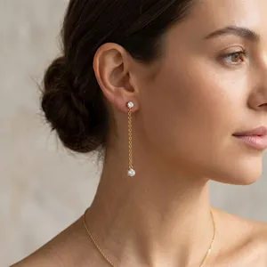 Elegant close-up of 18K gold plated tassel earrings with zircon studs on a model