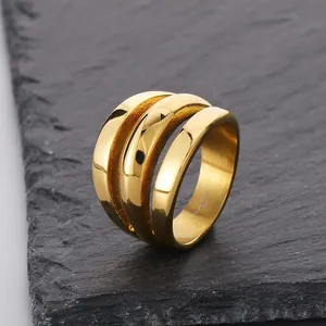 Close-up of minimalist gold triple layer stainless steel ring on slate background