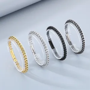 Detail view of woven wheat chain bracelets in gold, silver, black and antique finishes