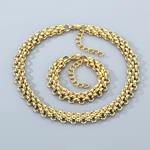 Detailed macro view of gold-tone stainless steel woven three-row chain jewelry set