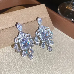 Close-up of sparkling floral chandelier earrings with square cubic zirconia detail