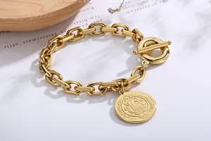 Detailed close-up of vintage gold coin pendant bracelet featuring a classic OT toggle clasp