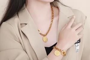 Vintage gold relief coin pendant with thick Cuban chain necklace and bracelet set on model