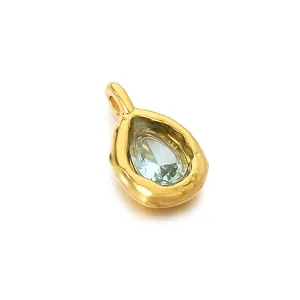 Luxury teardrop pendant with light blue crystal and hammered gold stainless steel frame