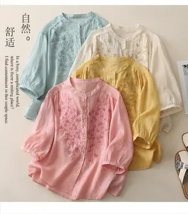 Detailed view of floral embroidery on cotton linen shirts in four soft pastel colors