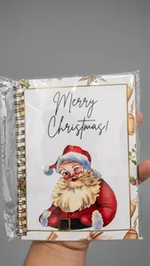 Detailansicht eines Ringbuchs mit Weihnachtsmann-Illustration und Merry Christmas Text