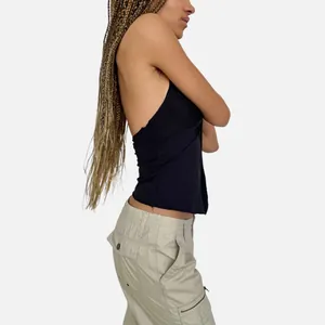 Women's black halter neck bow vest paired with beige cargo pants in a profile view