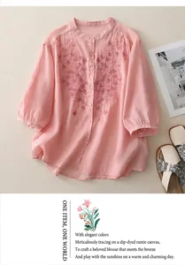 Detail of pink cotton linen shirt featuring delicate floral and butterfly embroidery