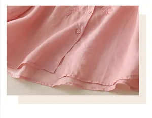 Close-up of pink cotton linen shirt with delicate leaf embroidery and small round buttons