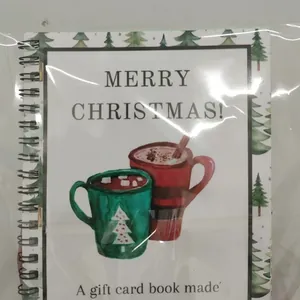 Spiral-bound Christmas gift card book featuring festive red and green mug illustrations