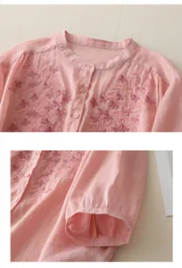 Close-up of pink linen shirt featuring intricate ethnic floral embroidery and small buttons