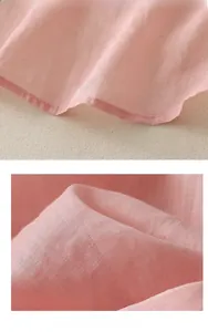 Close-up of pink linen fabric texture with neat stitching on an ethnic embroidery shirt