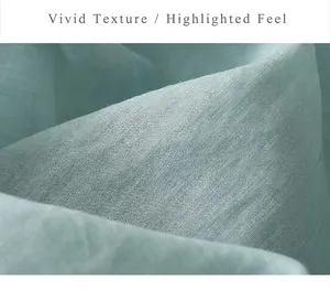 Close-up of light cyan linen fabric showing breathable texture and woven fiber details