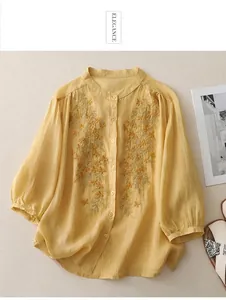 Macro detail of exquisite floral embroidery on a yellow cotton linen ethnic shirt