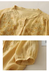 Detailed embroidery on yellow cotton linen shirt with vintage lantern sleeves and buttons