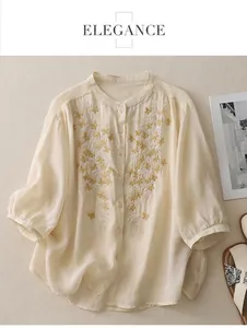 Close-up of golden butterfly embroidery on the neckline of a linen cotton shirt