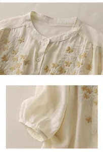 Detail of embroidered butterfly patterns and delicate stitching on a linen shirt