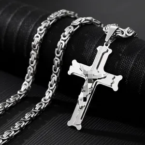 Macro detail of silver stainless steel crucifix pendant and thick Byzantine chain necklace