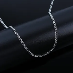 Detail shot of polished silver stainless steel curb chain links on a black stand