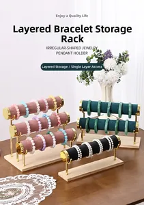 Three-tier velvet bracelet display stand with wooden base and golden metal support