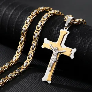 Close-up of a two-tone Byzantine chain and gold-silver cross pendant with Jesus relief