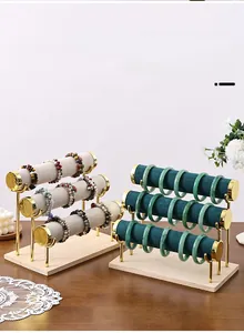 Three-tier T-bar jewelry display stand with velvet rods, gold metal and wooden base