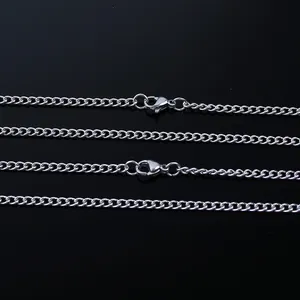Macro detail of silver stainless steel curb chain links with lobster clasp closure