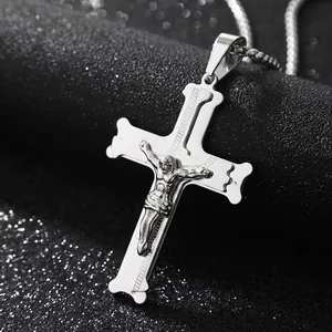 Macro shot of silver stainless steel crucifix pendant with detailed Jesus figure on ball chain