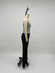 Side view of gray sleeveless knit vest and black slim-fit trousers on a mannequin