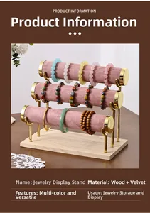 Three-tier jewelry stand detail with pink velvet rolls and a solid wood base for bracelets